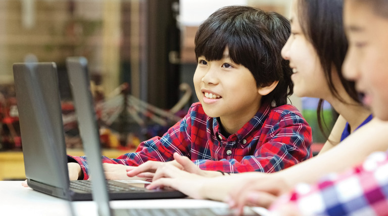 Students using laptops in school