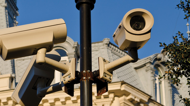 Security cameras installed on pole in front of historic building