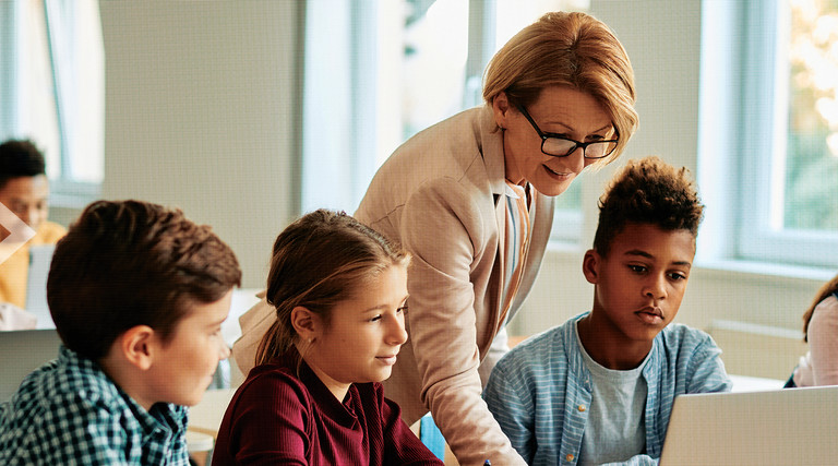 Teacher assisting students in the classroom