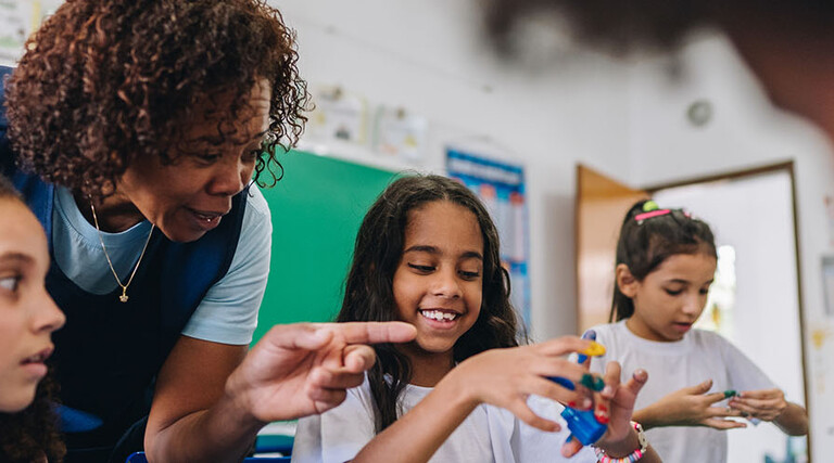 Teacher helping students during art class