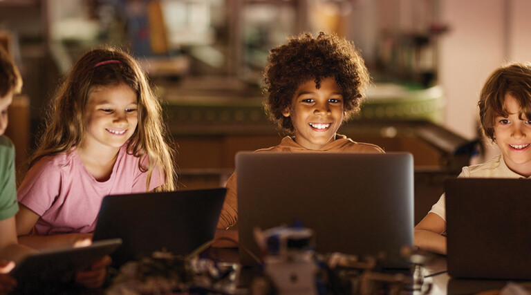 Students learning on laptop computers in a K12 classroom
