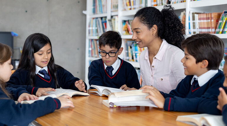 Teacher working with students at a private school