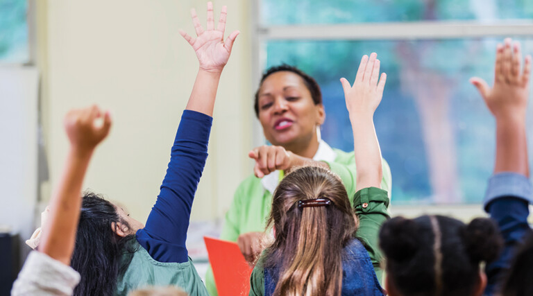 Teacher and students in elementary school classroom