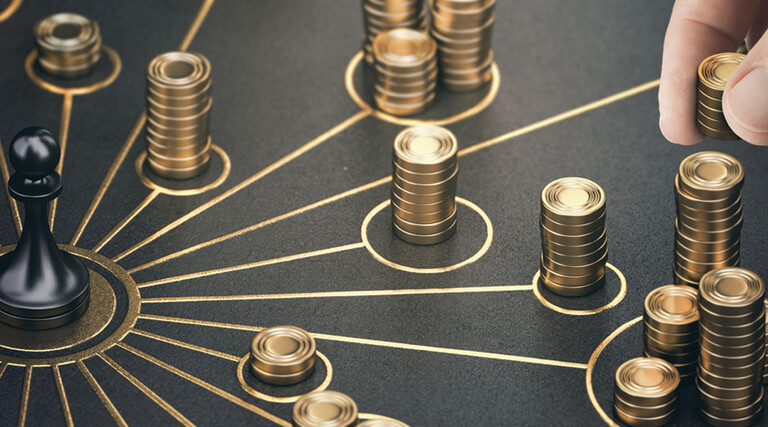 Chess piece surrounded by stacks of gold coins
