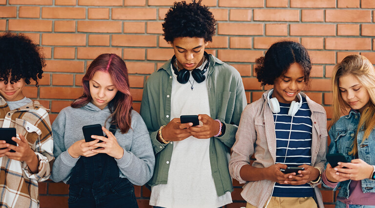 Students looking at phones in school