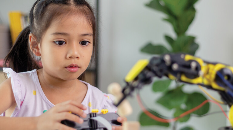 K12 student working on steam project with robot