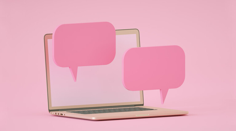 computer against pink backdrop with floating pink speech bubbles to indicate chatroom