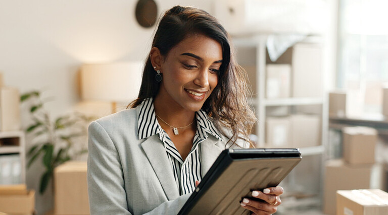 Person using tablet around boxes