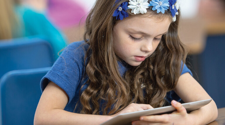 Student using tablet in class