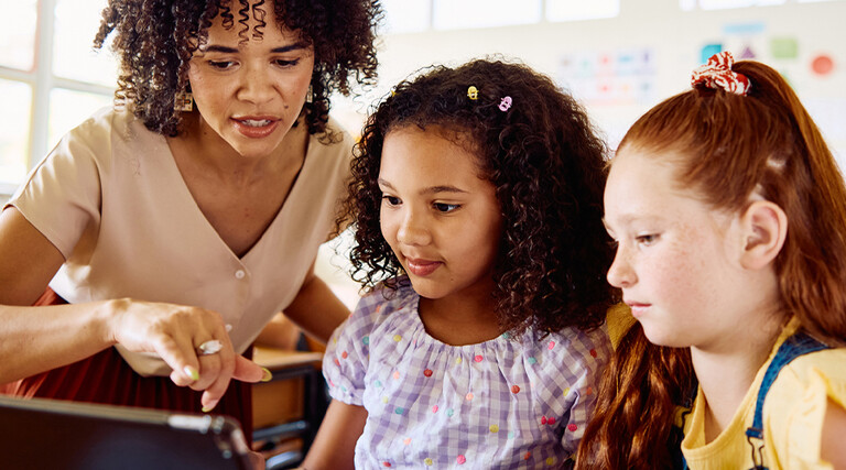 School teacher helping students