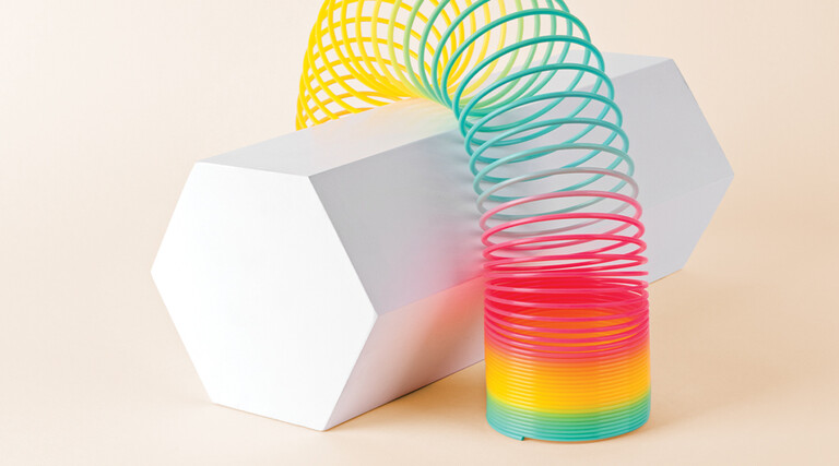 Flexible Multi Colored Coil Striding Hexagon Shape on White Background