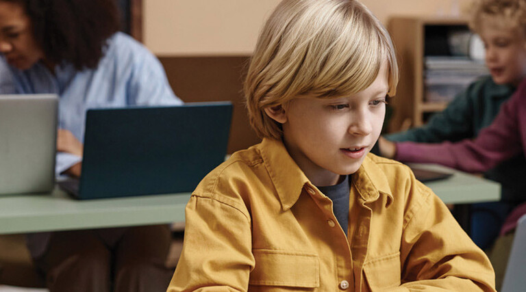 Boy on Laptop in classroom