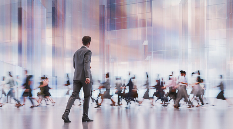 man walking in front of crowd
