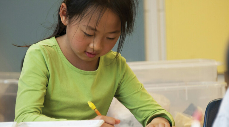 A K-12 student focusing and working on a creative makerspace project