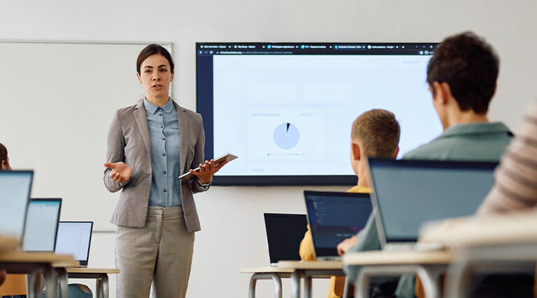 Teacher instructing class with technology