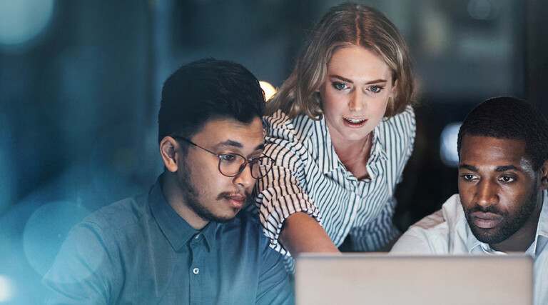 Coworkers using a laptop