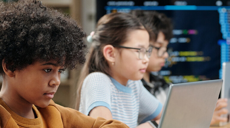 Students using laptops in school