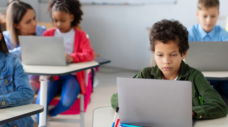 Students using devices in class