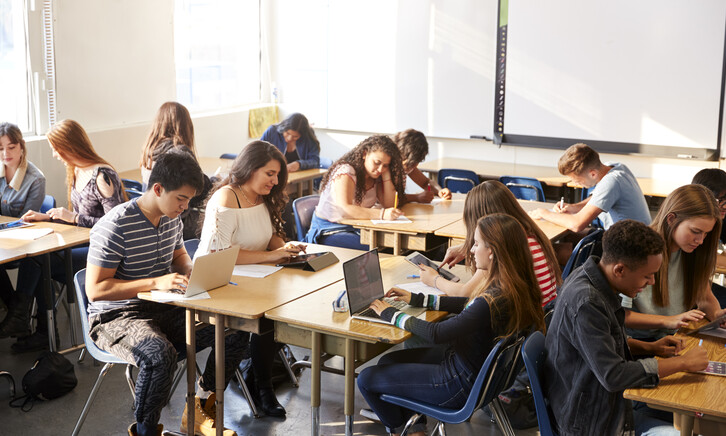 Students working at desks together in a classroom