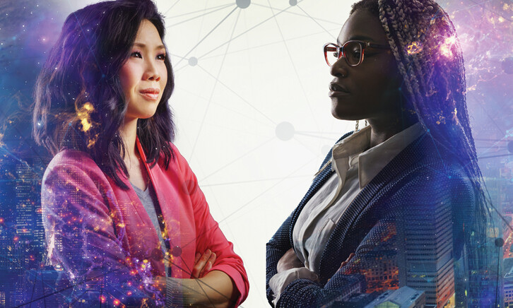 Image shows two women looking at each other with their arms crossed and a cityscape behind them
