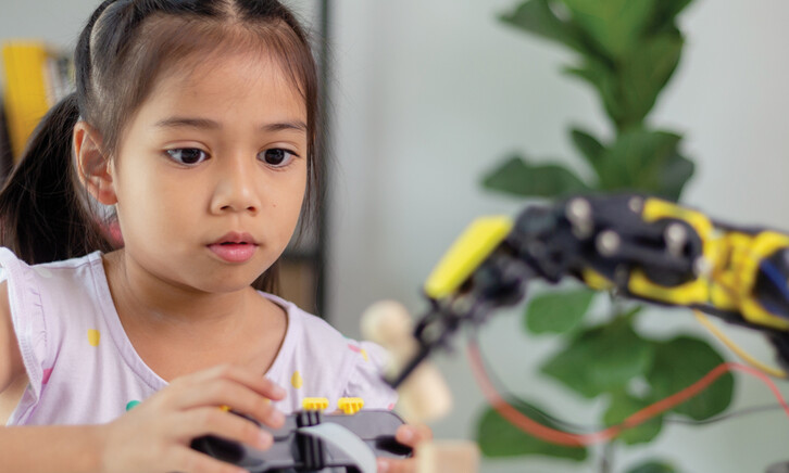 K12 student working on steam project with robot
