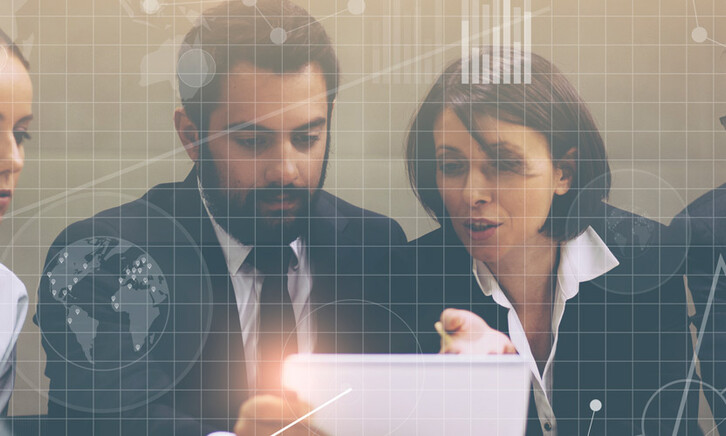 People at a laptop with grid