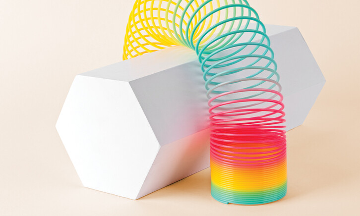 Flexible Multi Colored Coil Striding Hexagon Shape on White Background