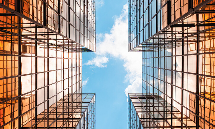 Digital twins concept showing the sky between two glass buildings