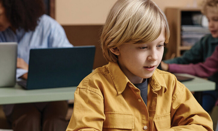 Boy on Laptop in classroom