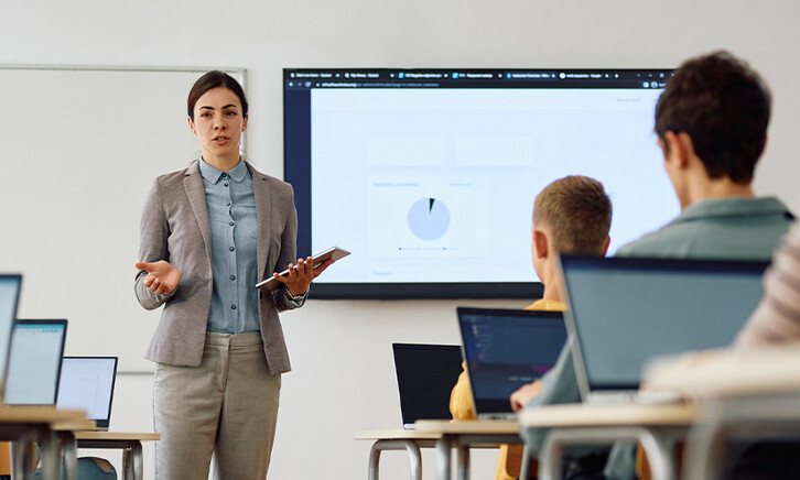 Teacher instructing class with technology