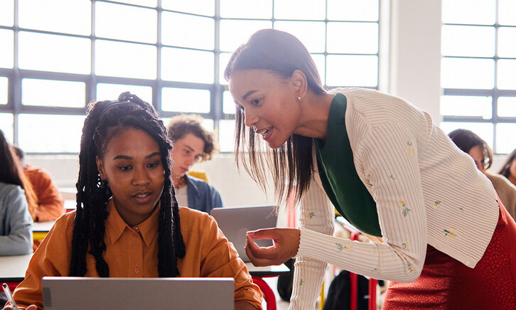Teacher helping student in class
