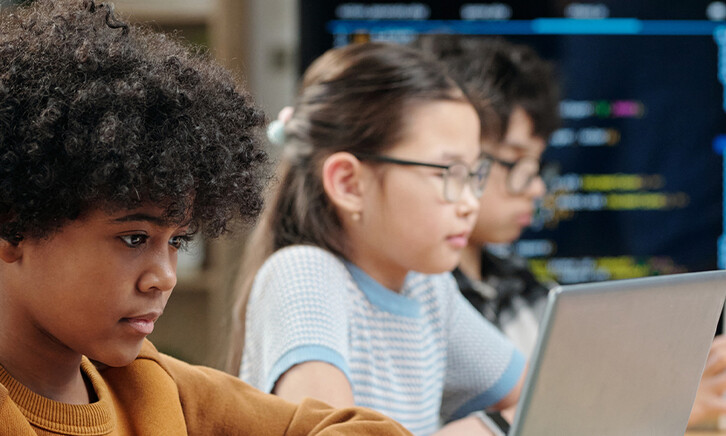 Students using laptops in school