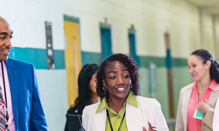 Diverse group of educators walking in hallway
