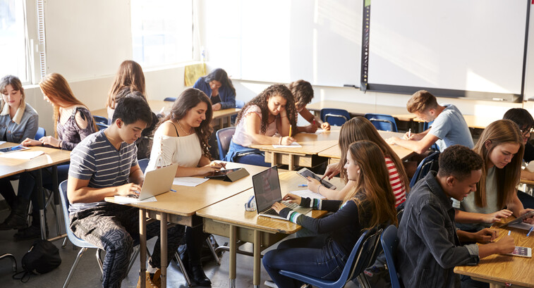 Students working at desks together in a classroom