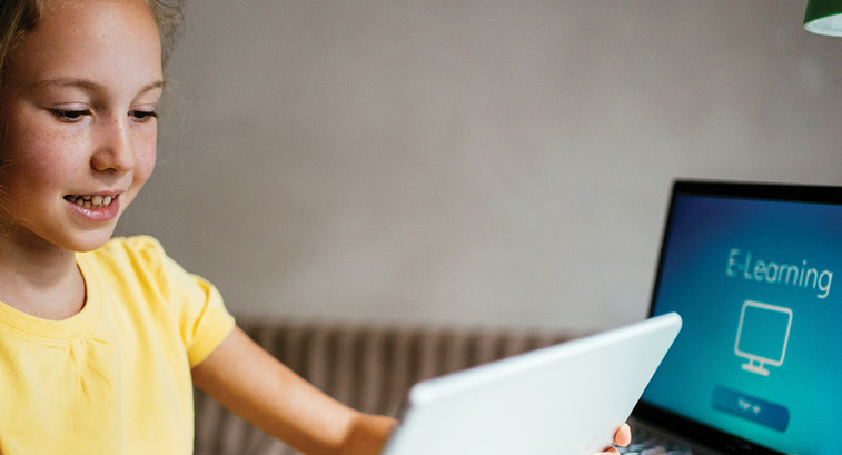 Girl on tablet and computer for e-learning