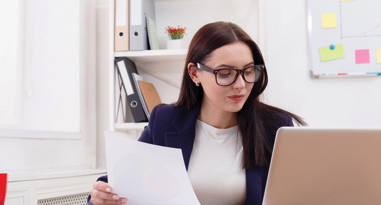 Admin auditing at laptop in office