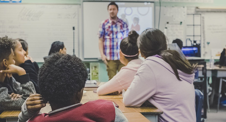 Teacher lecturing K-12 students