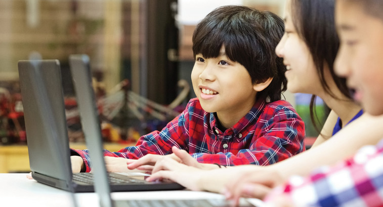 Students using laptops in school