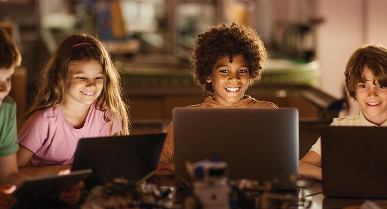 Students learning on laptop computers in a K12 classroom