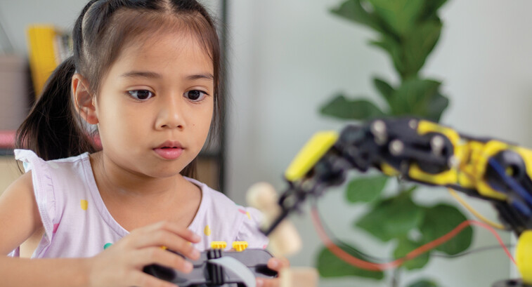 K12 student working on steam project with robot