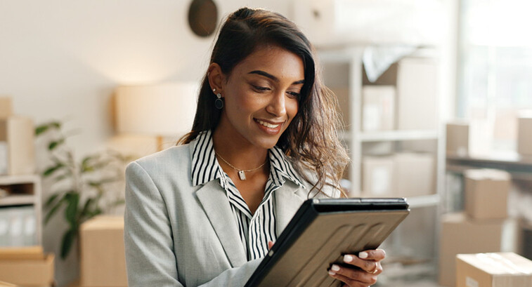 Person using tablet around boxes