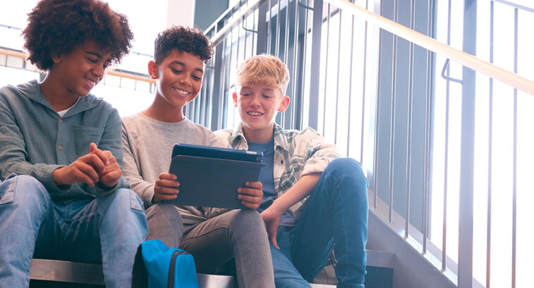K12 students using tablet on school stairwell with great wi-fi