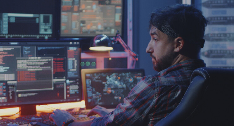 Security alerts appearing on multiple screens while man watches
