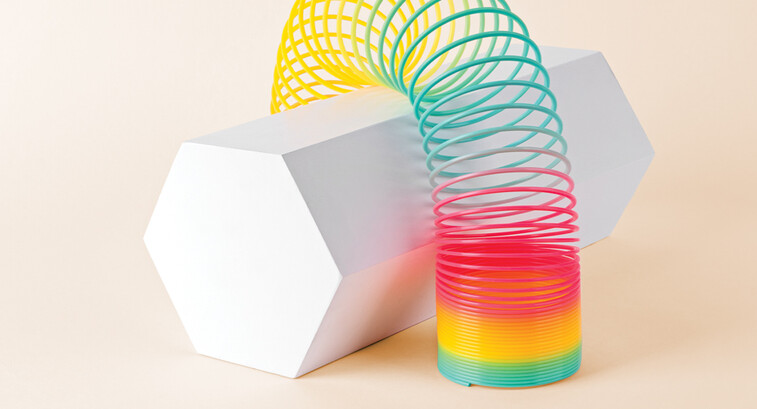 Flexible Multi Colored Coil Striding Hexagon Shape on White Background