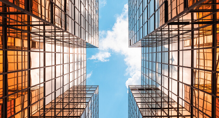 Digital twins concept showing the sky between two glass buildings