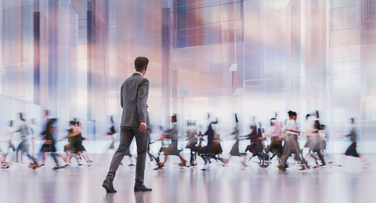 man walking in front of crowd