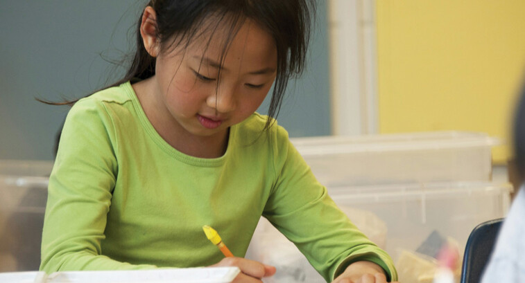A K-12 student focusing and working on a creative makerspace project