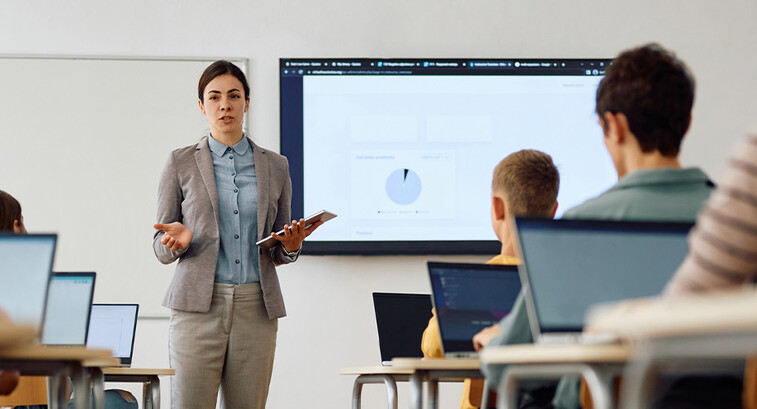 Teacher instructing class with technology