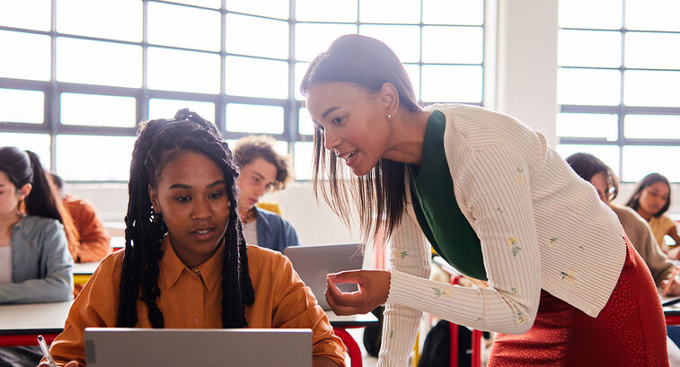 Teacher helping student in class