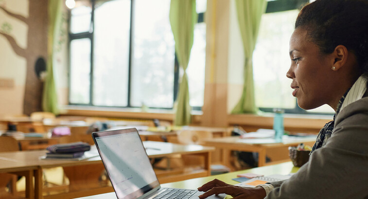 Teacher using laptop
